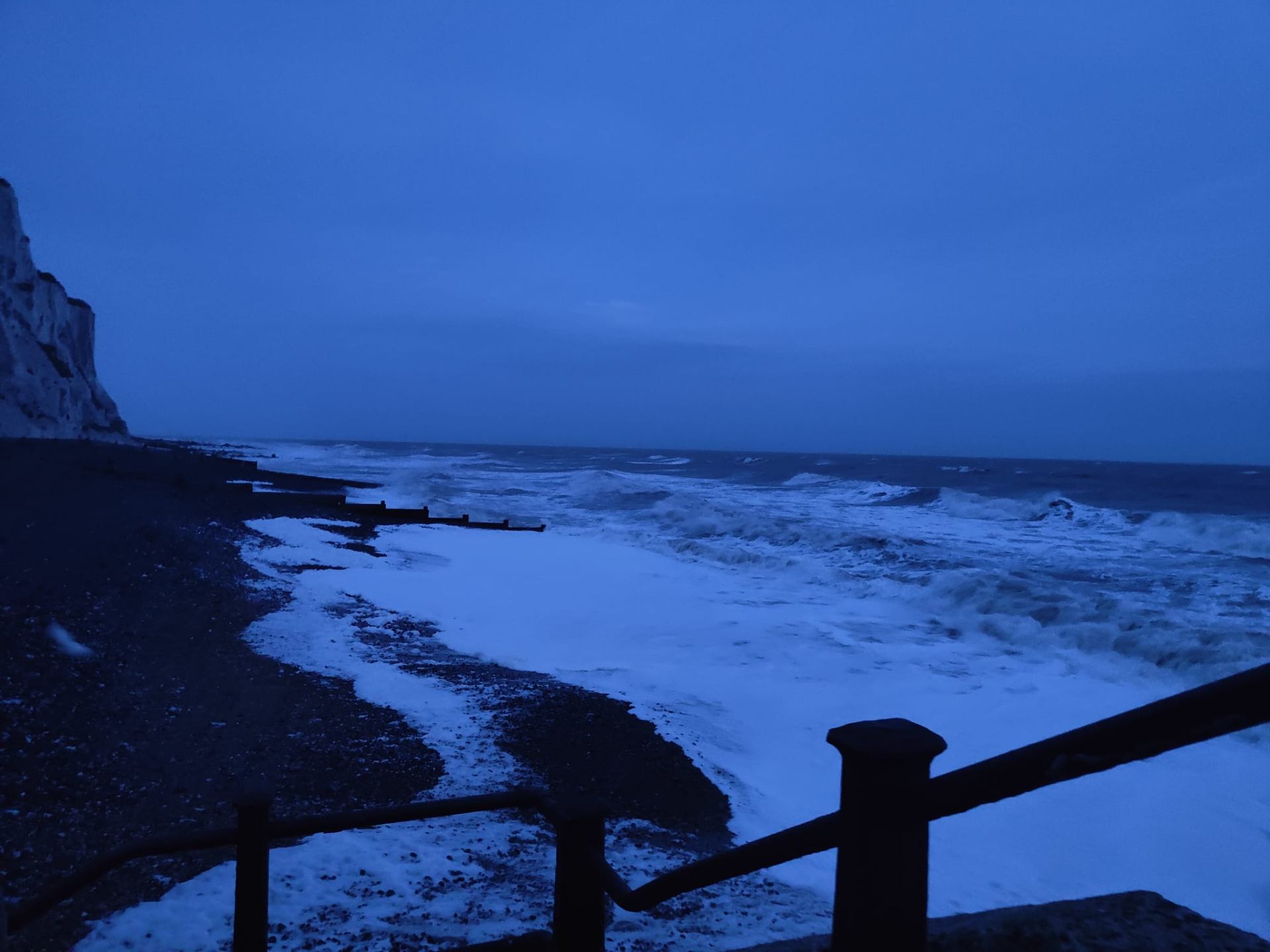Chalk cliffs and stormy sea at dusk